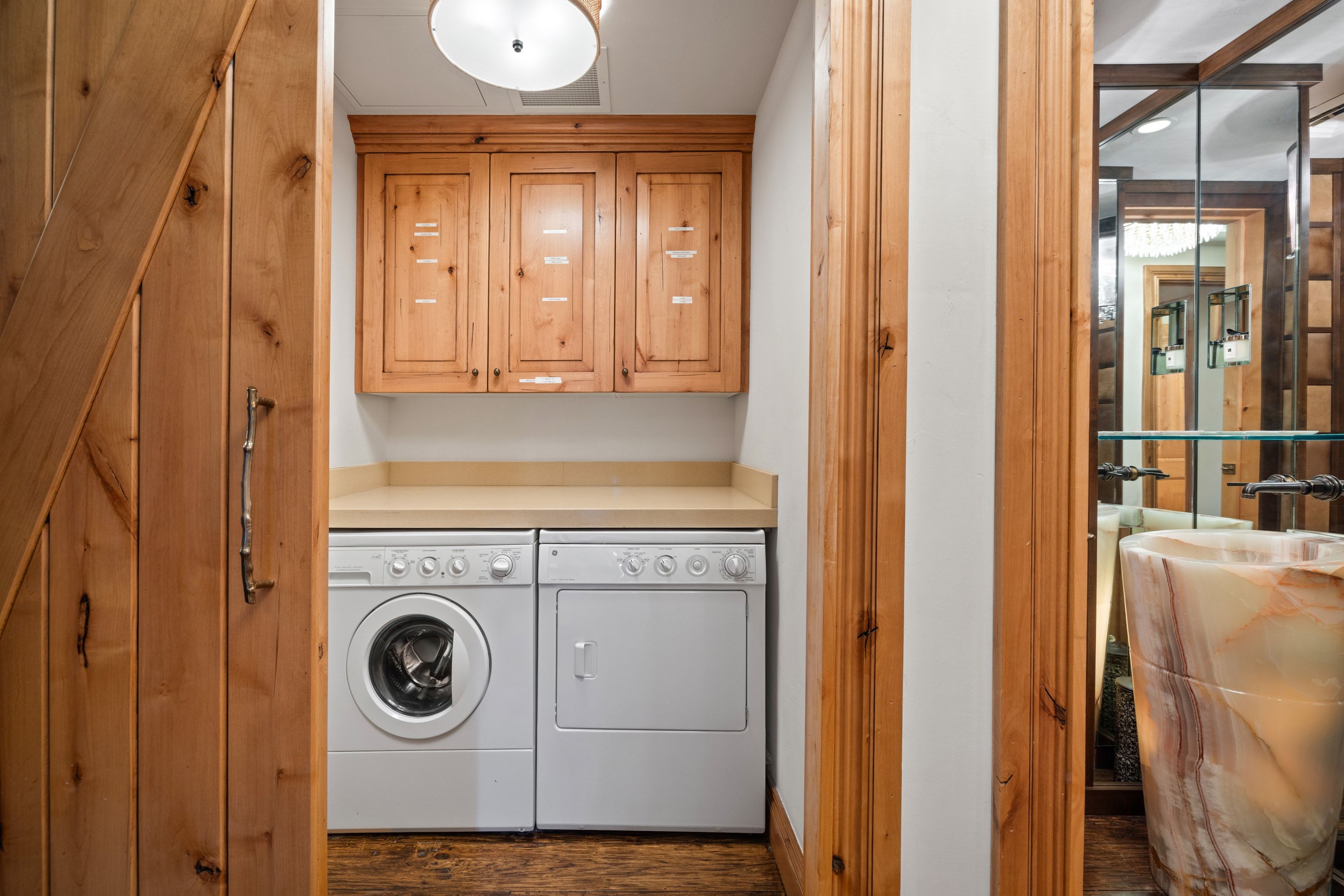 Dedicated laundry area featuring a countertop, upper cabinetry, and a washer and dryer