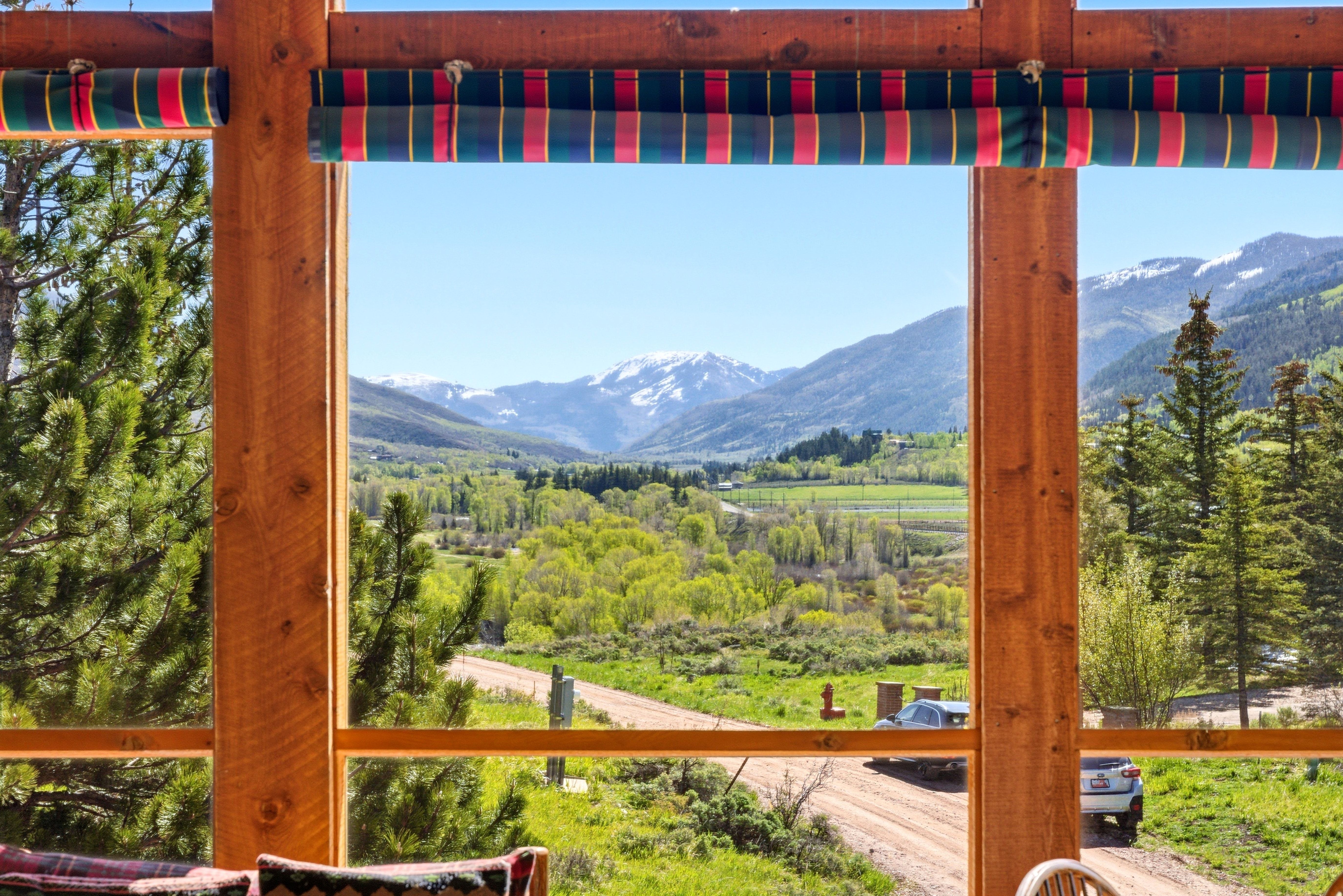 Expansive window framing a mountain and valley landscape