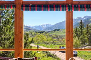 Expansive window framing a mountain and valley landscape