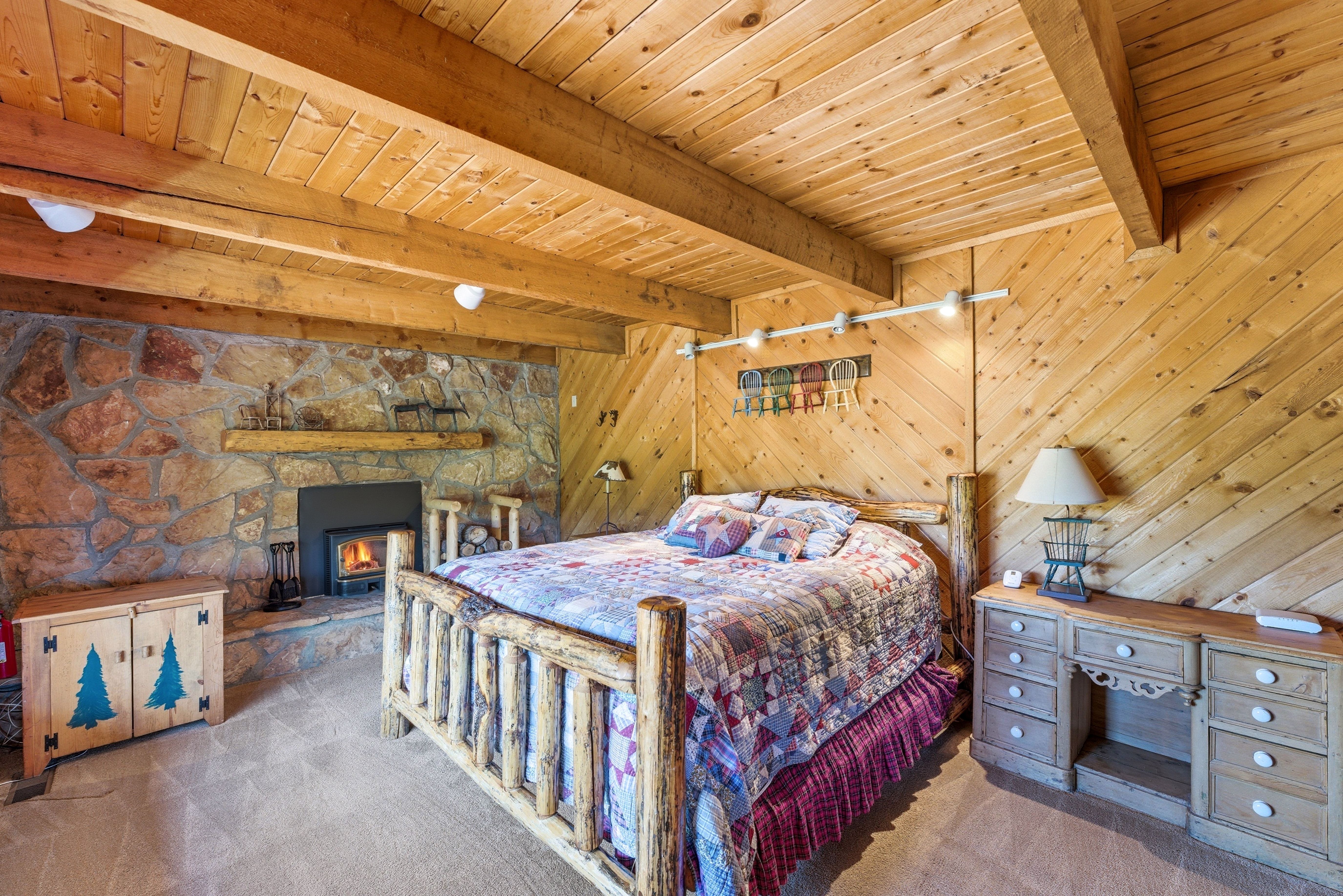 Stone-faced fireplace with a substantial timber mantel