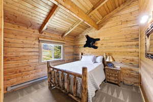 Wood-paneled room featuring vaulted ceilings with exposed beams, a window with outdoor scenery, and carpeted flooring