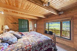 Expansive window with roller shade overlooking a verdant mountain landscape