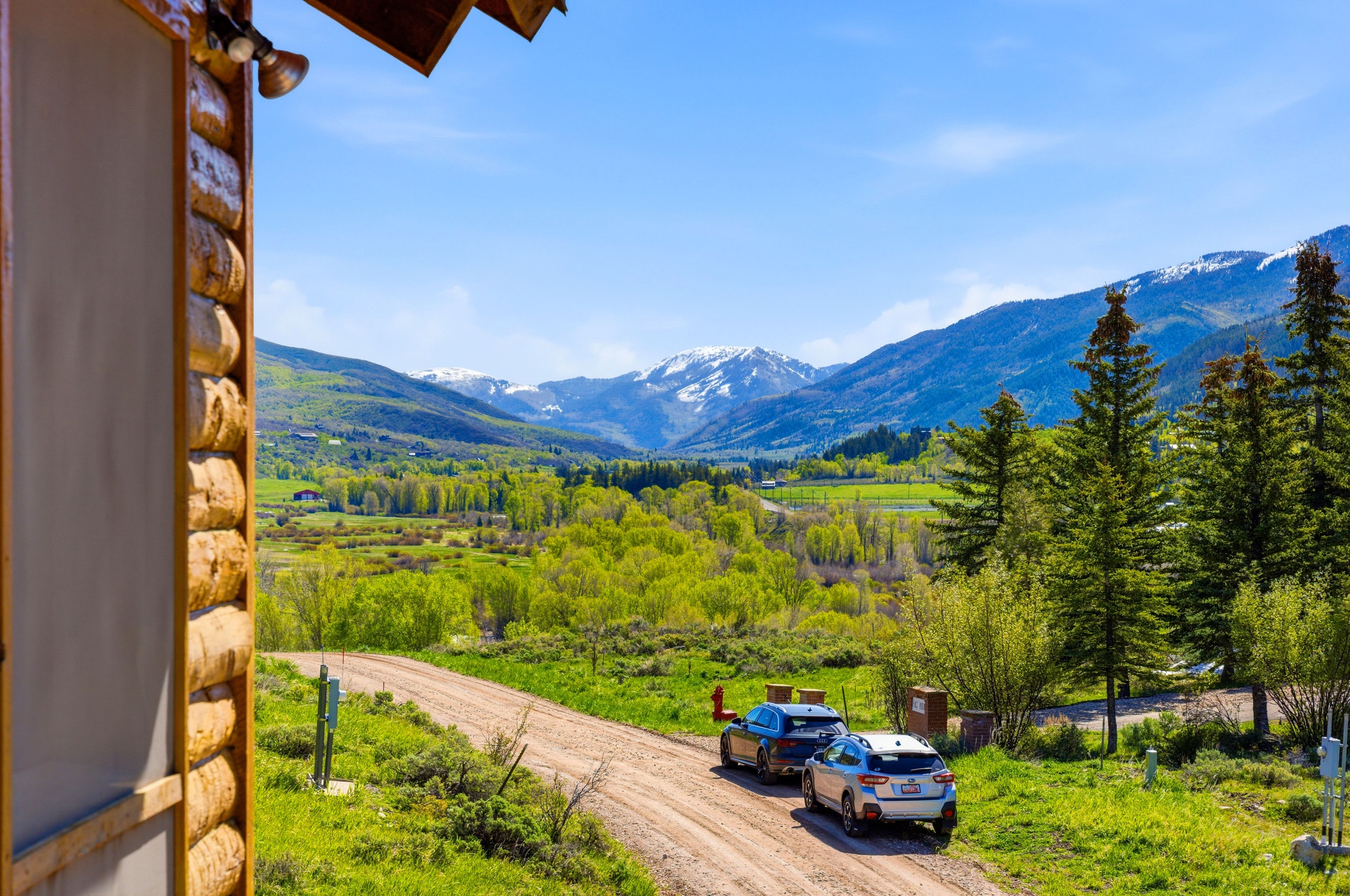 Expansive mountain scenery featuring snow-capped peaks and verdant valleys