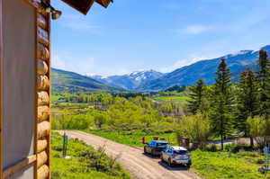 Expansive mountain scenery featuring snow-capped peaks and verdant valleys
