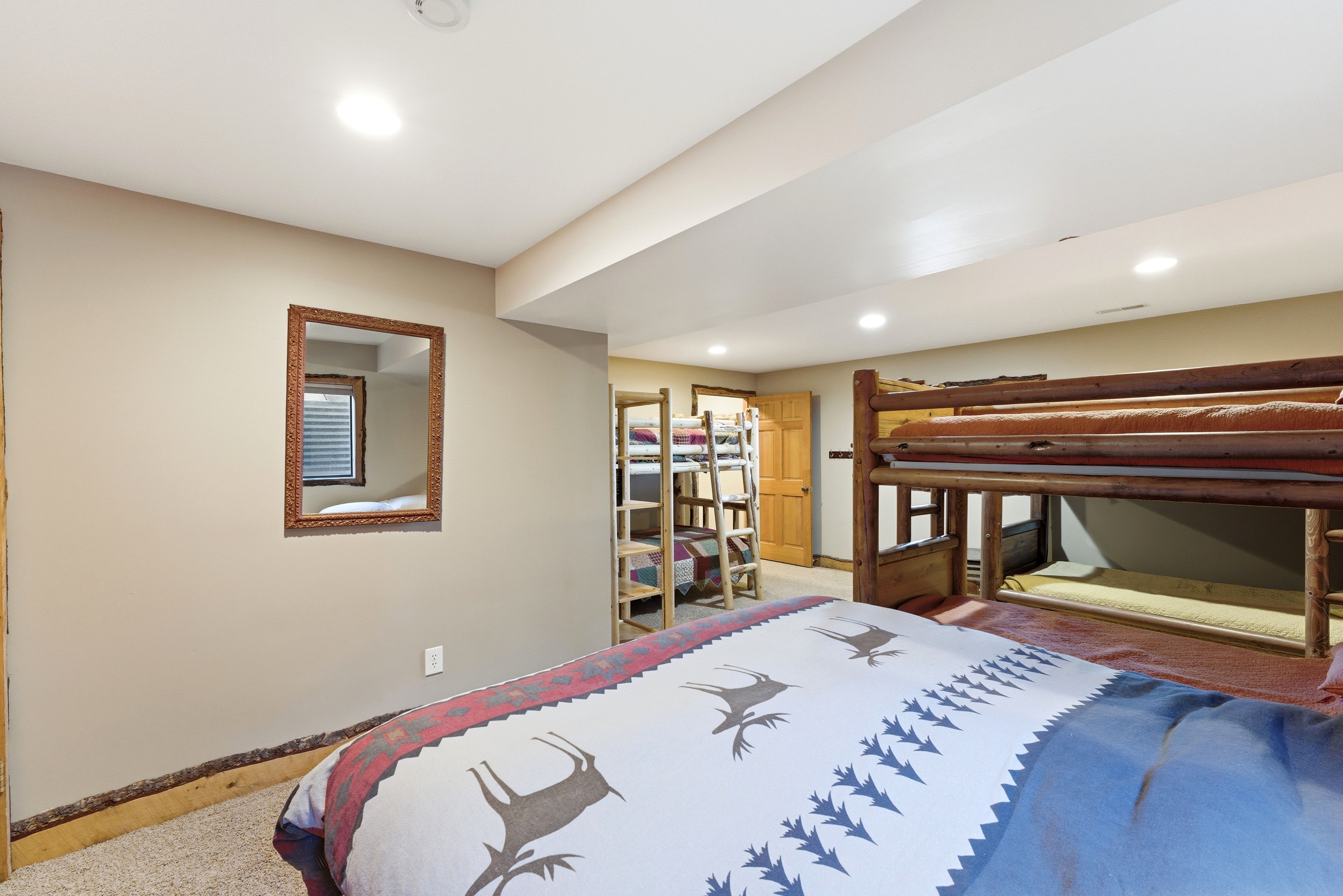 Spacious room featuring neutral painted walls with a wood-finish trim, recessed lighting, and light-toned carpet flooring