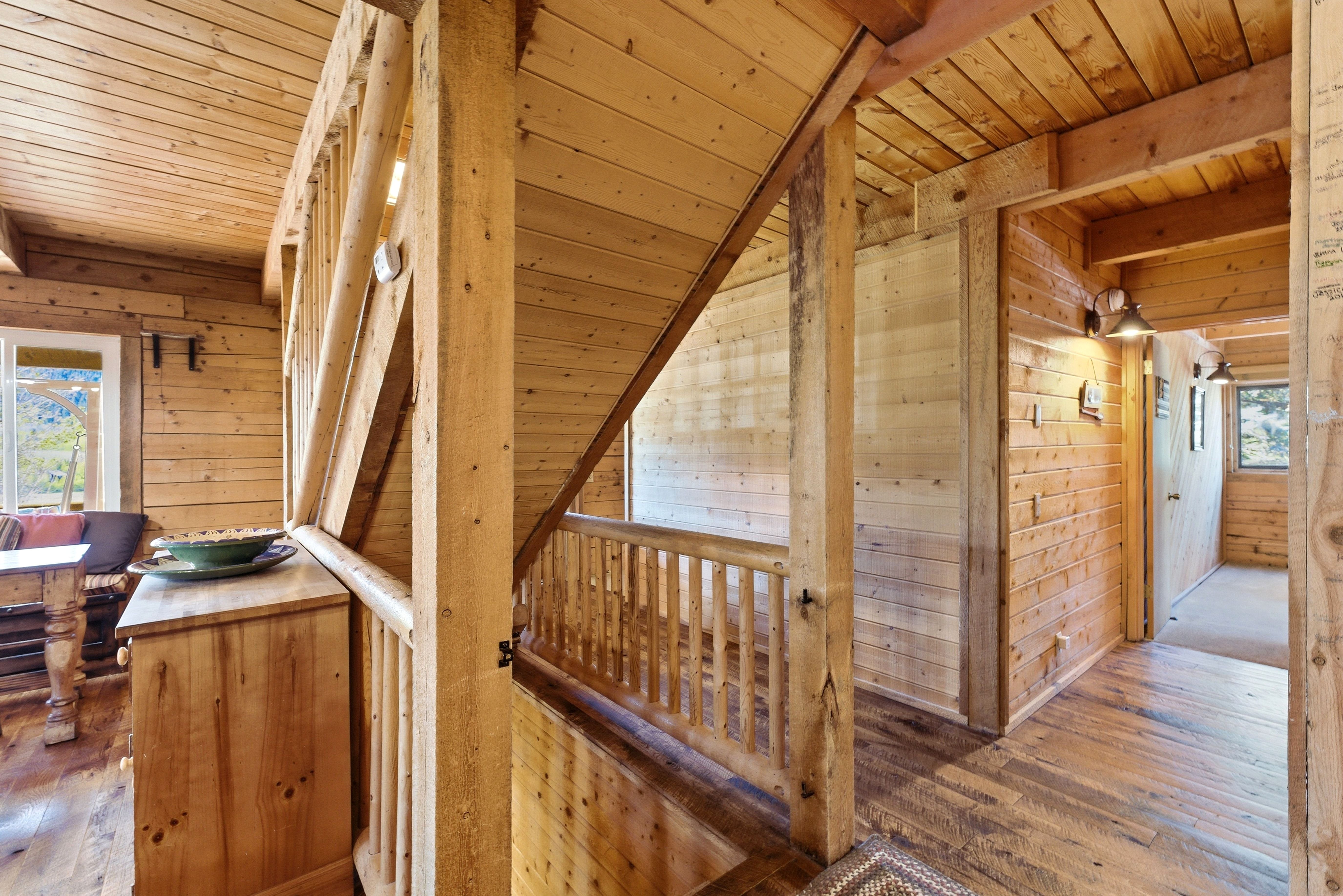Exposed wood plank walls and ceilings throughout, complemented by wood-finish flooring