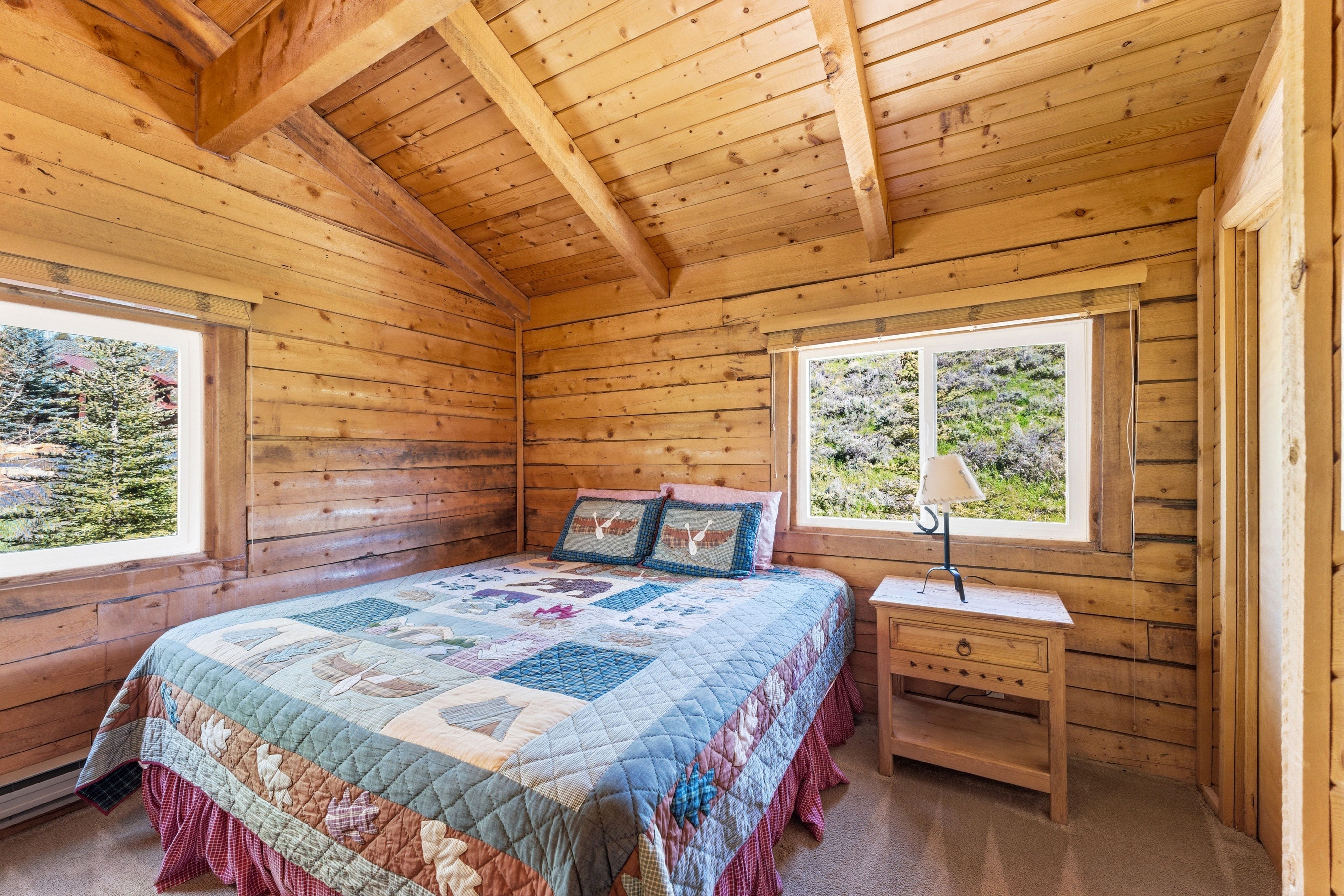 Interior room featuring natural wood plank walls and exposed wood beams