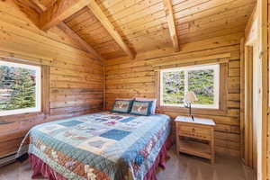Interior room featuring natural wood plank walls and exposed wood beams