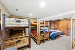 Room with light beige carpeting and recessed lighting