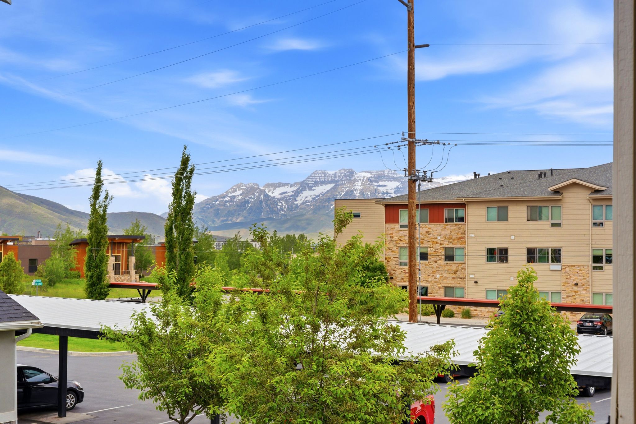 View from primary bedroom with Snow-capped mountains create a striking backdrop for this property