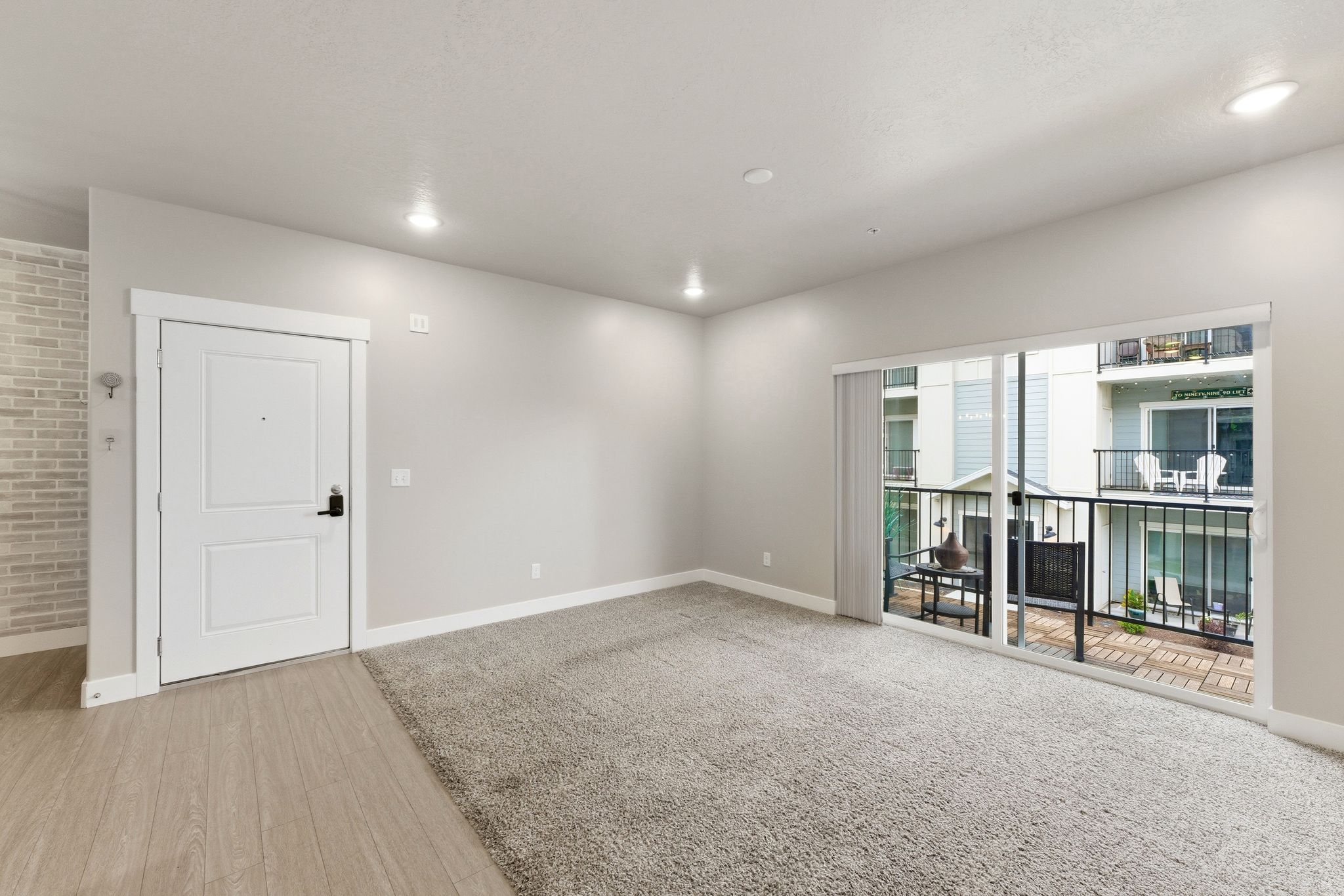 Living area with light gray walls, recessed lighting