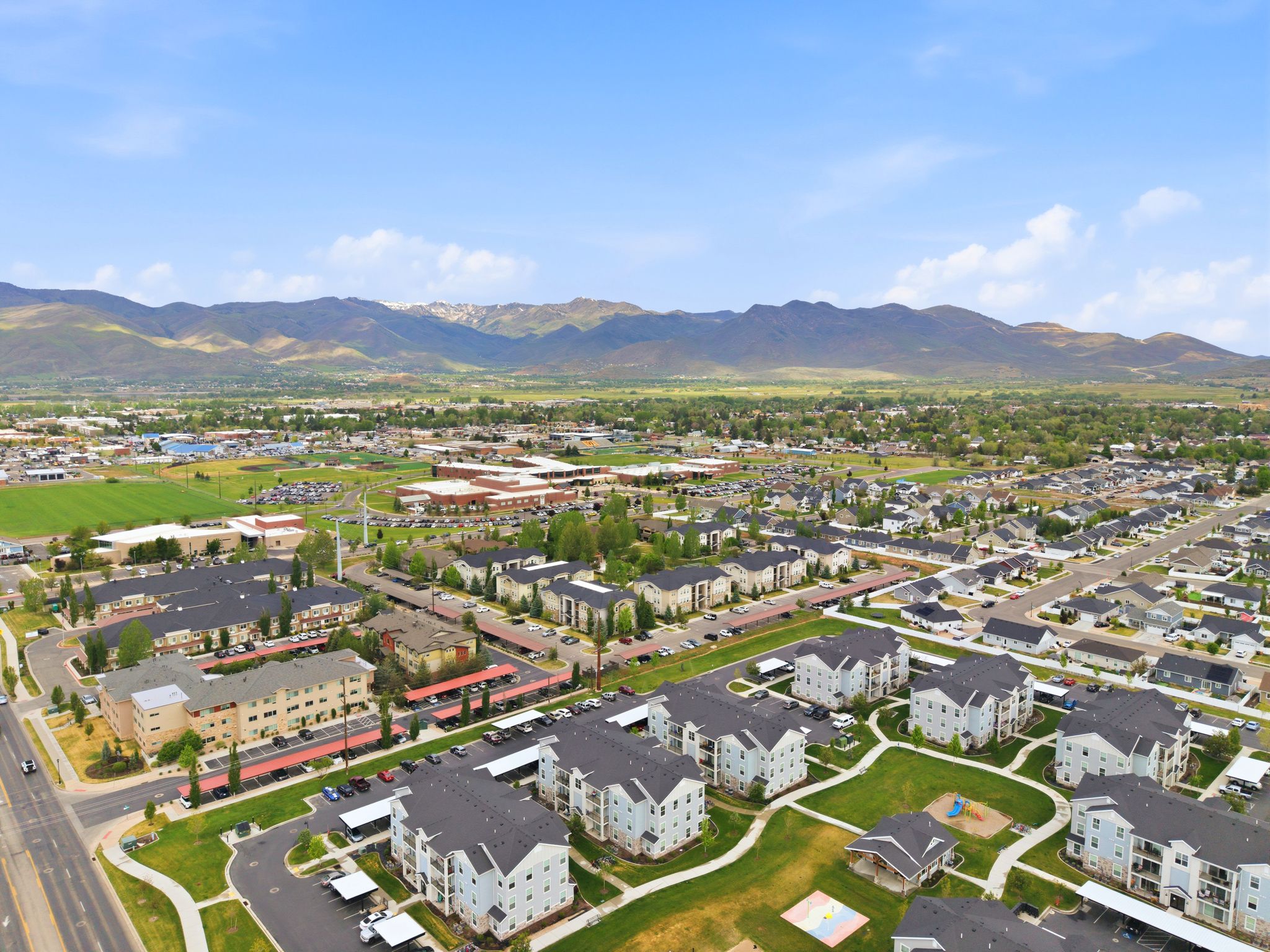Aerial perspective showcasing a residential community with multi-story buildings and single-family homes