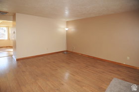 Wood-finish flooring throughout, complemented by light-toned wall finishes and wood baseboards