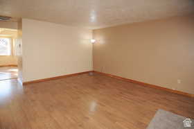 Wood-finish flooring throughout, complemented by light-toned wall finishes and wood baseboards