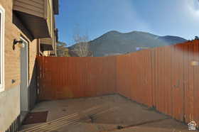 Private outdoor patio area featuring a wooden privacy fence