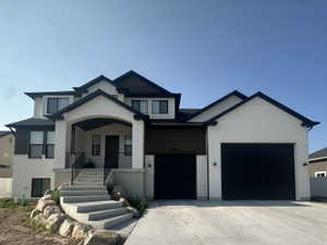 Contemporary three-story residence with a white brick, wood siding and black trim.