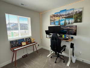 Bright interior space featuring a window with horizontal blinds, neutral wall paint, and a textured ceiling