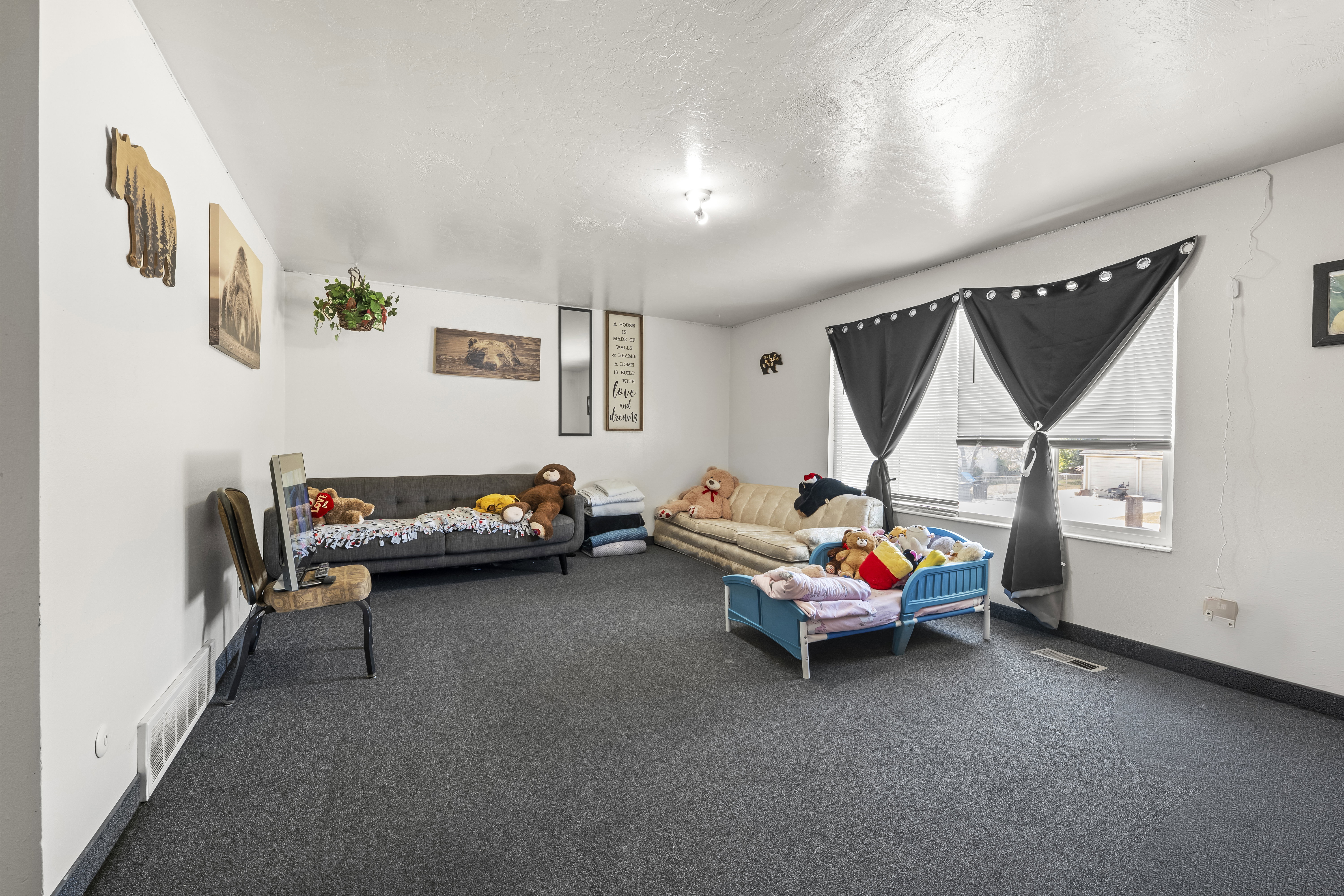 Spacious room featuring dark gray carpeting and light-colored walls