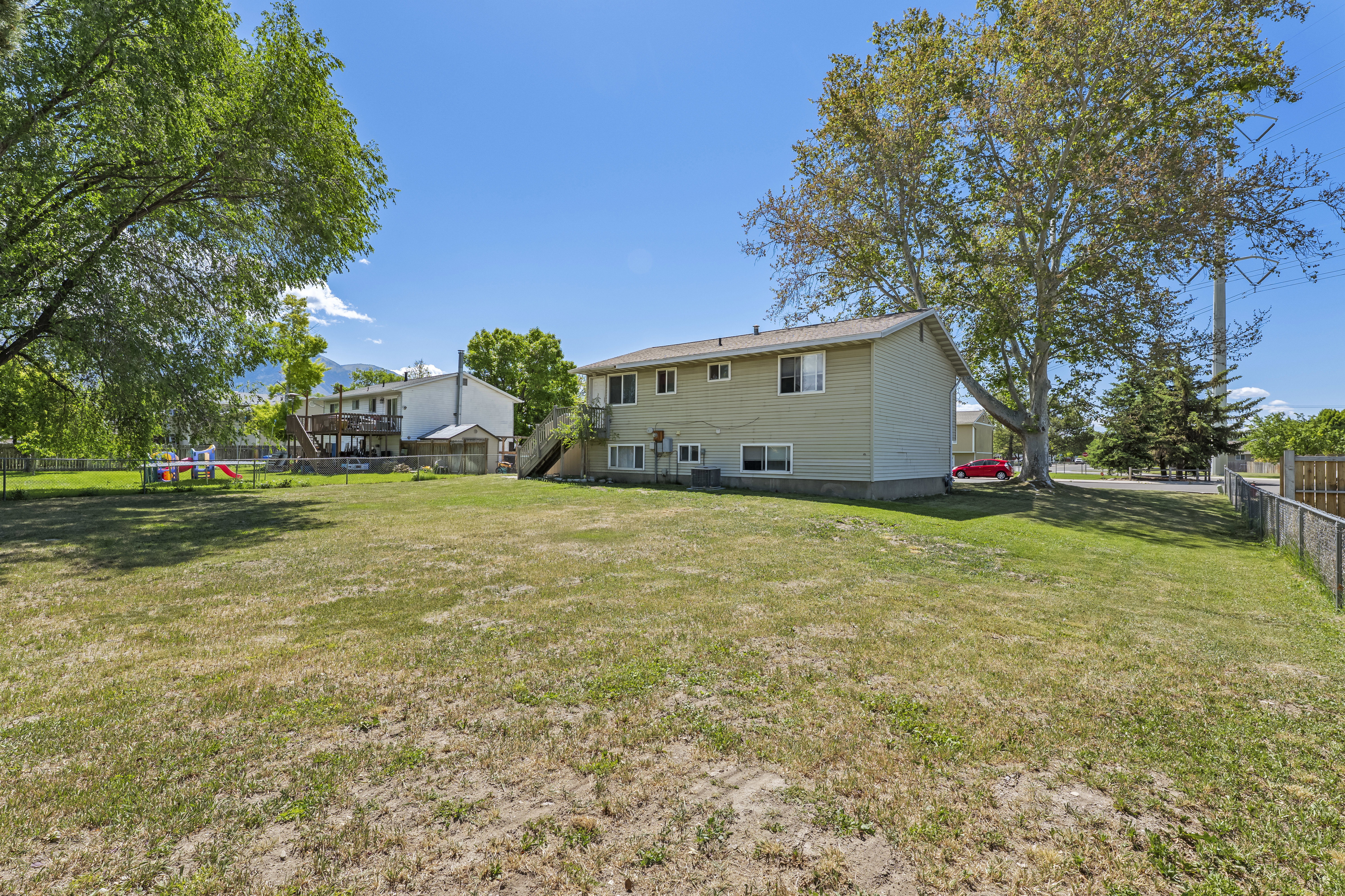 Expansive rear yard with mature trees