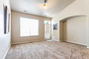 Furniture Removed by AI. Spacious room featuring neutral carpeting and light-colored walls
