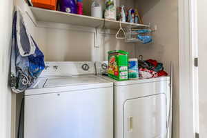 Dedicated laundry area featuring a white top-load washing machine and a white front-load dryer