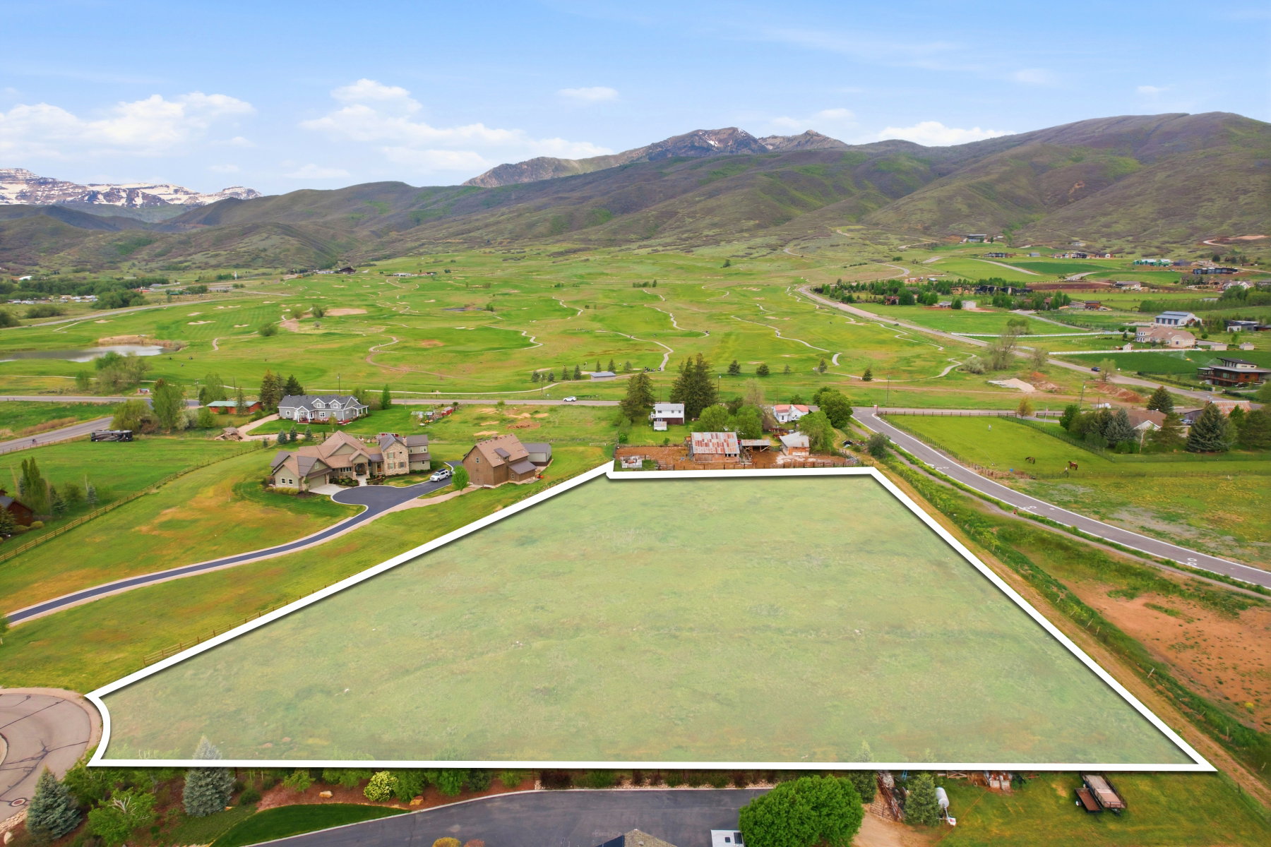 Expansive land parcel featuring a level, grass-covered terrain
