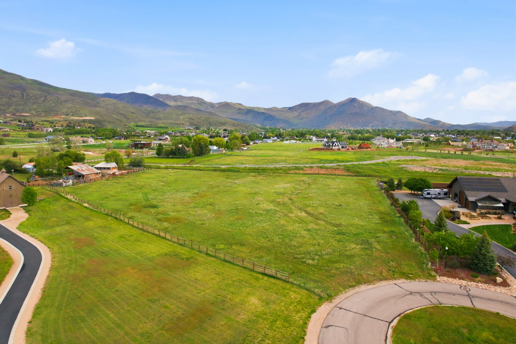 Expansive green acreage with distant mountain scenery