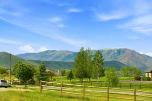 Expansive landscape featuring rolling hills and distant mountains