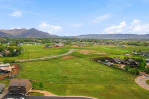 Expansive green acreage with distant mountain scenery