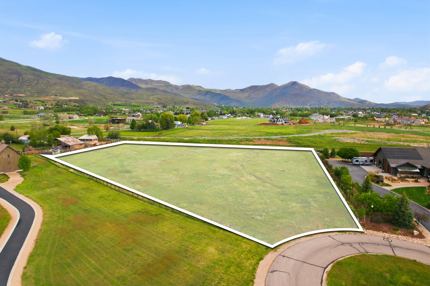 Expansive residential lot featuring a level, grass-covered terrain