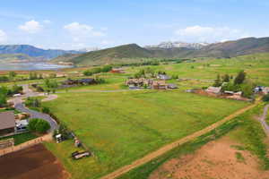 Expansive green landscape featuring distant mountains and a body of water