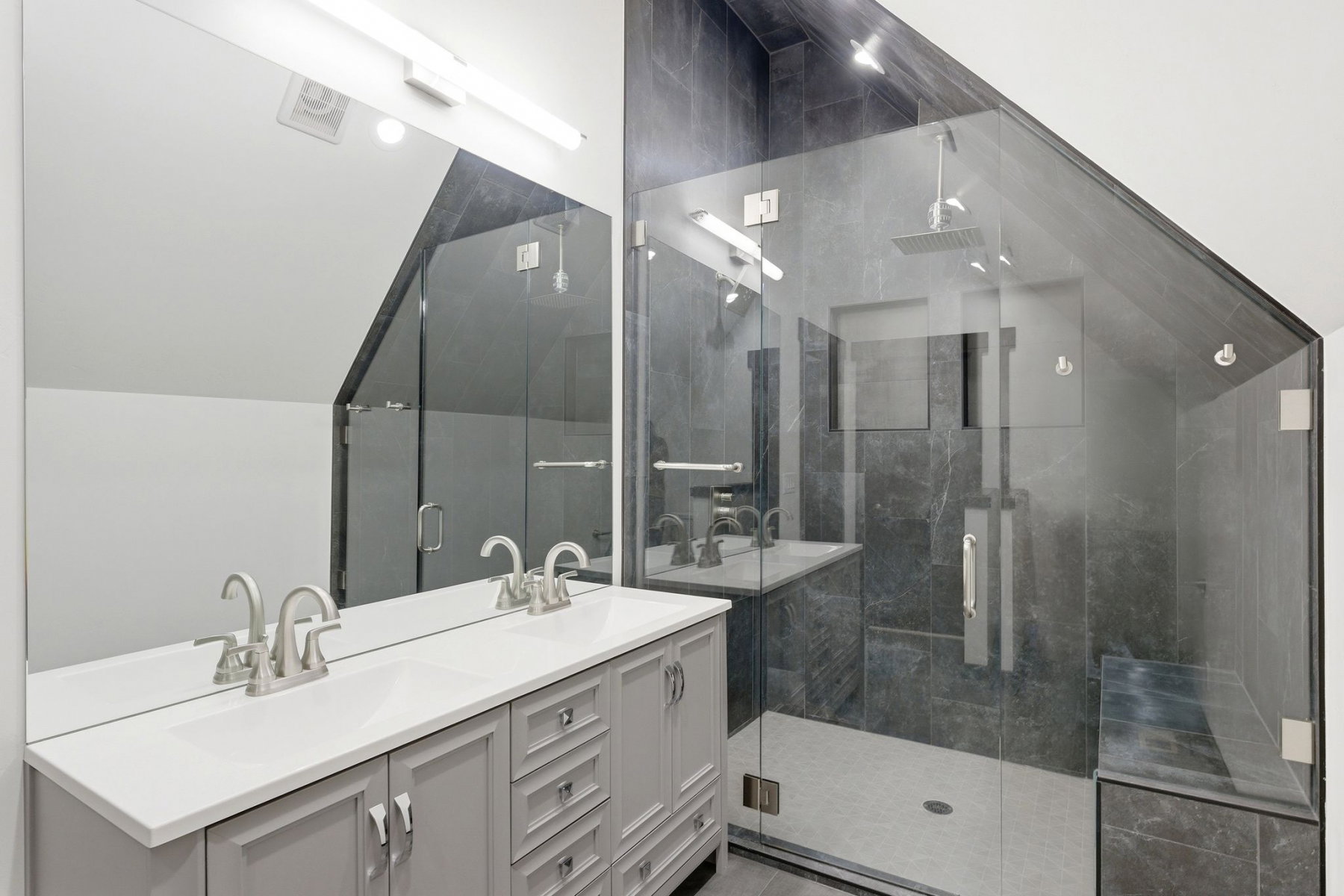 Bathroom featuring a dual-sink vanity with white countertop and brushed nickel fixtures