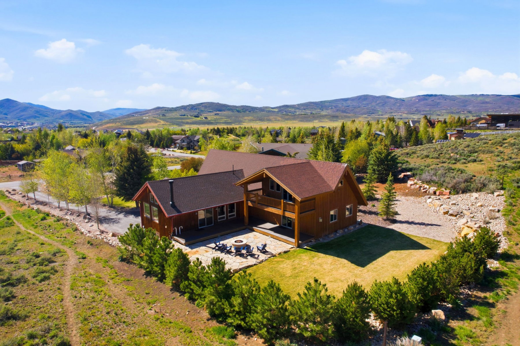 Wood-sided residence featuring a multi-level design and a brown shingle roof