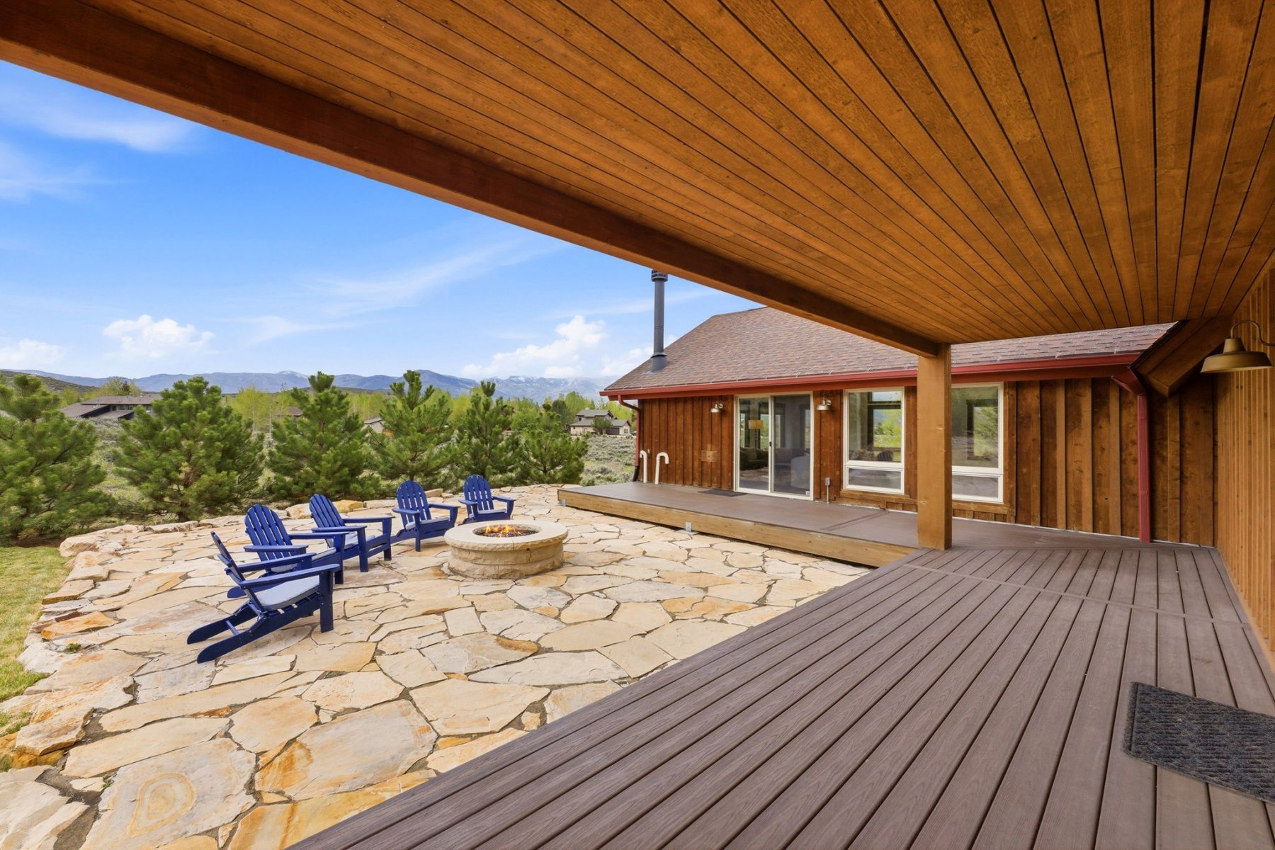 Expansive stone patio with built-in fire pit