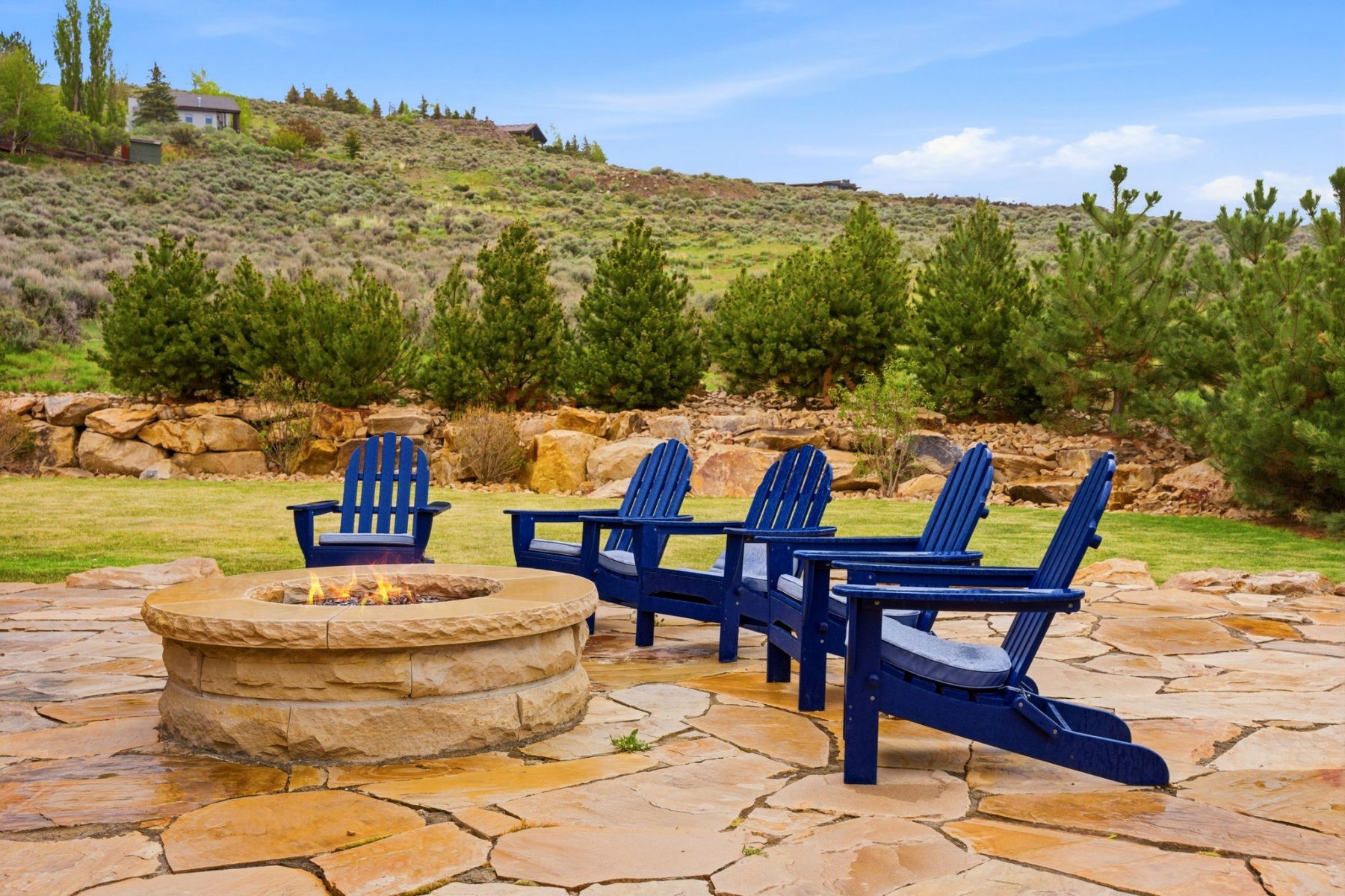 Flagstone patio featuring a stone-clad fire pit