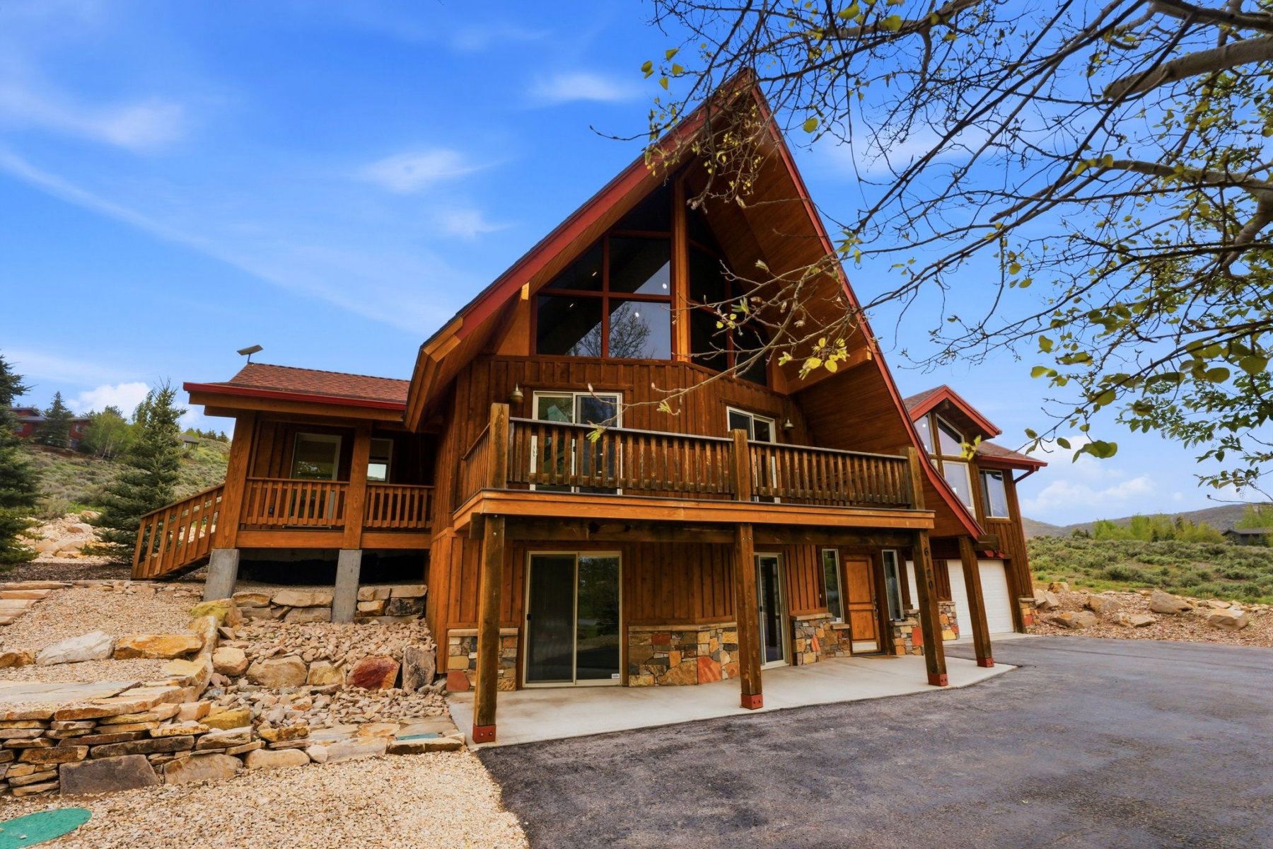 A-frame residence with wood siding and a red roof
