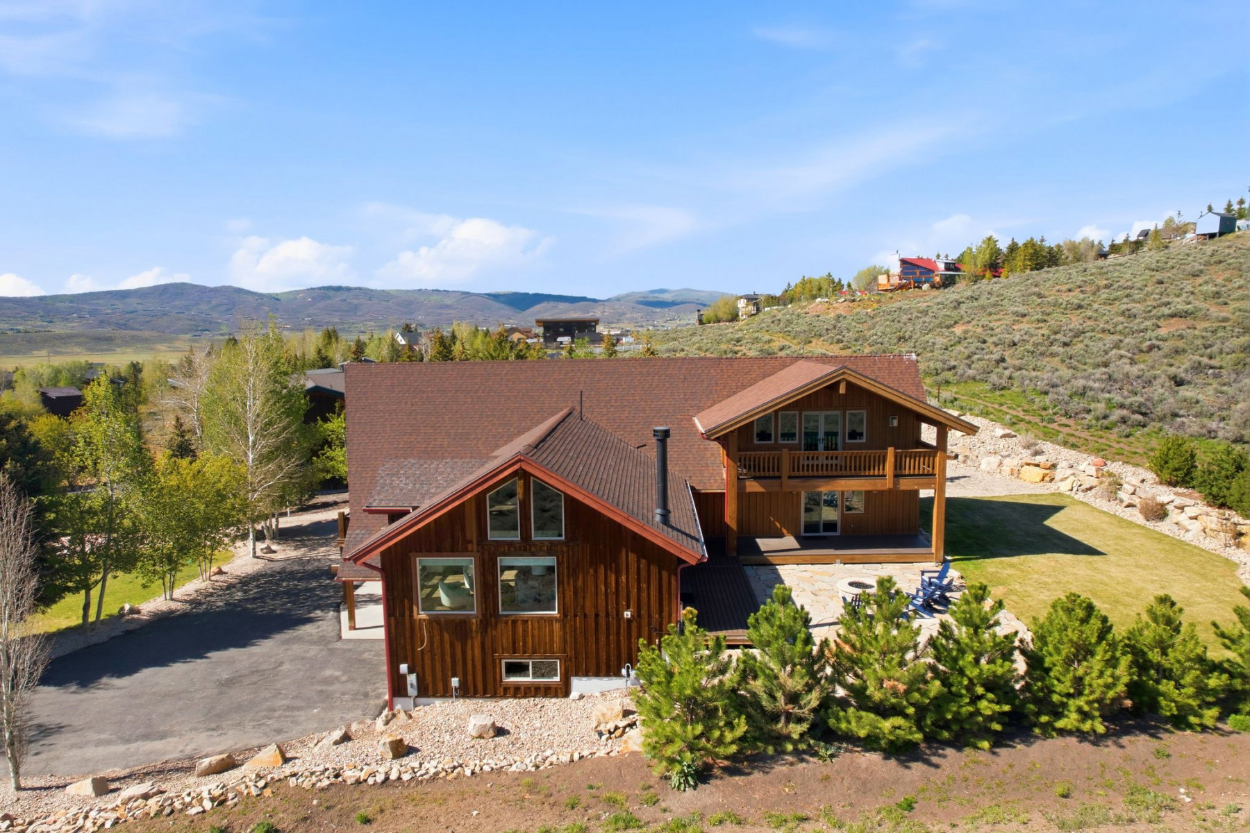 Contemporary home with a wood-clad exterior, tiered pitched roofline, and multiple windows