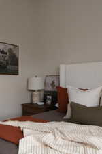 Upholstered headboard with an adjacent wood-finish nightstand