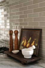 Subway tile backsplash in a neutral tone with a light gray grout, complemented by a stone-finish countertop