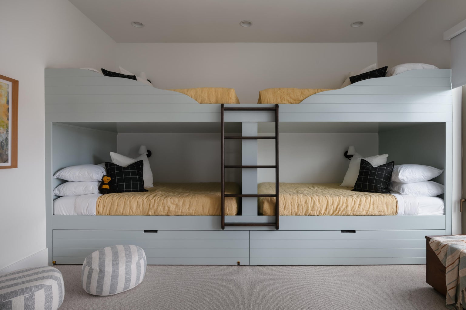 Custom built-in bunk beds featuring integrated ladder access and individual sconce lighting