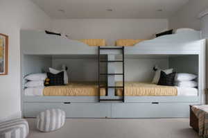 Custom built-in bunk beds featuring integrated ladder access and individual sconce lighting