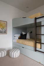 Built-in bunk bed system featuring a light blue finish, integrated storage drawers, and a dark wood ladder