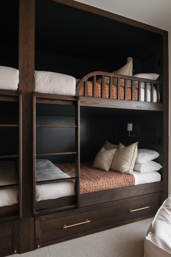 Built-in bunk beds crafted from dark wood-finish material