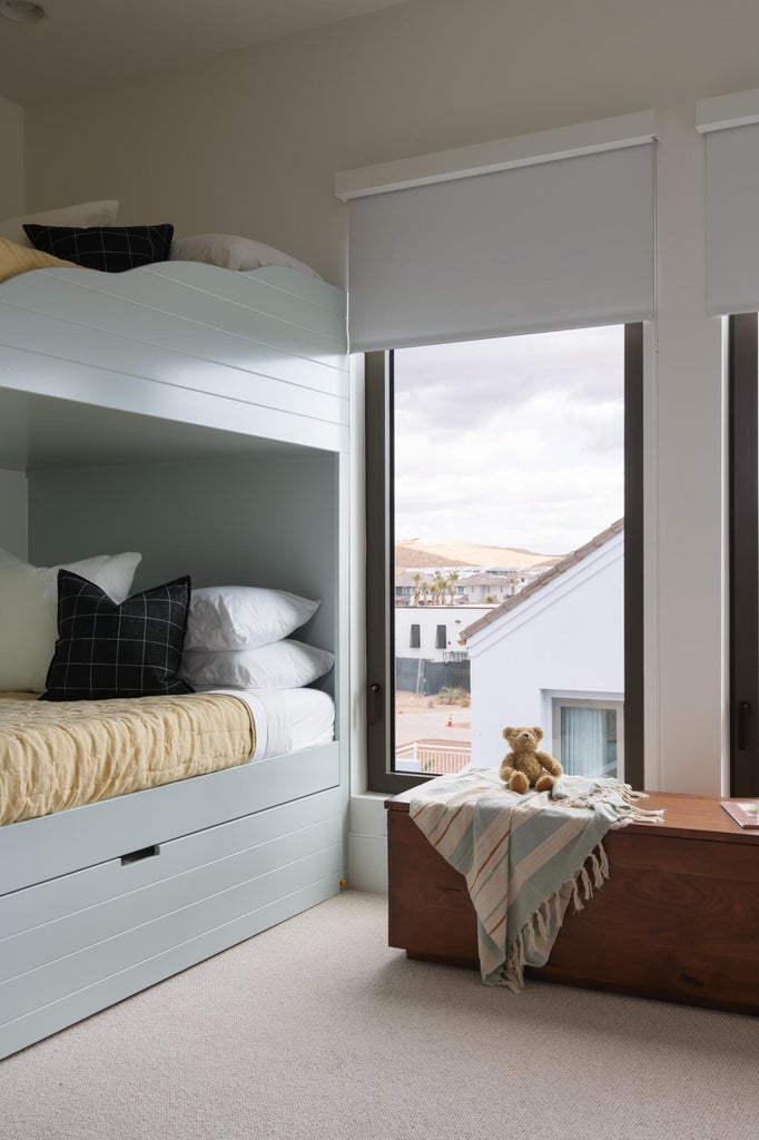 Built-in bunk beds featuring shiplap detailing and integrated storage drawers