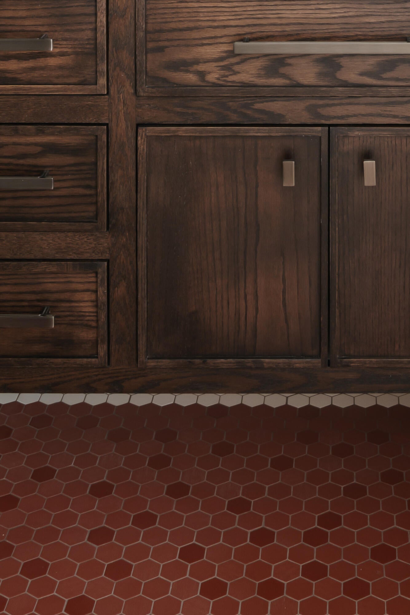 Dark wood cabinetry with multiple drawers and double-door storage