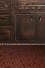 Dark wood cabinetry with multiple drawers and double-door storage