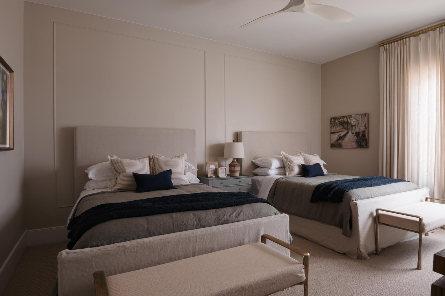 Carpeted room featuring panel molding, a modern ceiling fan, and full-height window drapery