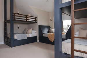 Built-in bunk beds with integrated storage drawers, slatted headboards, and wall-mounted sconces