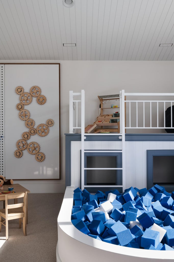 Built-in bunk bed structure featuring a ladder and a padded play area