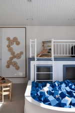Built-in bunk bed structure featuring a ladder and a padded play area